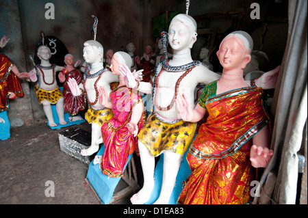 Finished, painted and dressed deities ready for offering at festival pujas, Kumartuli district, Kolkata, West Bengal, India Stock Photo