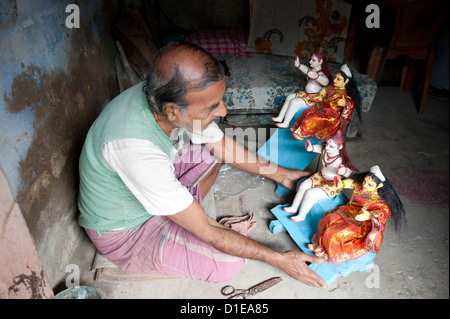 Sculpture with painted and dressed deities at festival pujas, Kumartuli district, Kolkata, West Bengal, India Stock Photo