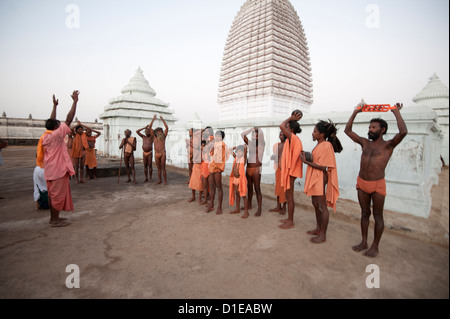 Joranda monks in ritual prayer at dusk at temple containing dhuni, eternal butter lamp, Joranda, Dhenkanal, Orissa, India Stock Photo