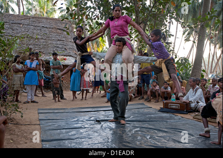 Four dancers whirling round as part of a traditional Gotipua (single boy) temple dance performance, Ballia, rural Orissa, India Stock Photo