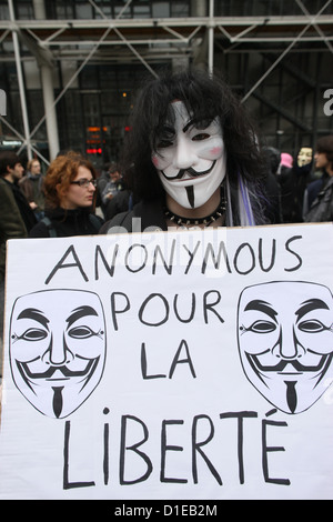 Protestor wearing Guy Fawkes mask of the Anonymous movement and based on a character in the film V for Vendetta, Paris, France
