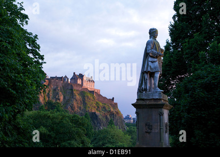 Statue of Allan Ramsay, with Edinburgh Castle at sunset from West Princes Street Gardens, Edinburgh, Scotland, United Kingdom Stock Photo