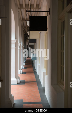 Passage in old classical building with shops' signboards Stock Photo