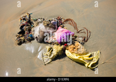 Horizontal close up of non biodegradable rubbish washed up on Papanasam beach at Varkala, Kerala. Stock Photo