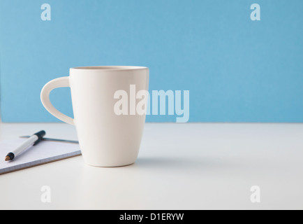 coffee or tea cup sits on table or desk Stock Photo
