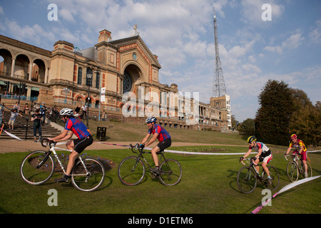 Cyclists ride by Alexandra Palace during the Rapha Super Cross race in London, England, United Kingdom Stock Photo