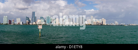 Miami cityscape skyline from Rickenbacker causeway on cloudy morning with Manatee zone slow speed sign Stock Photo