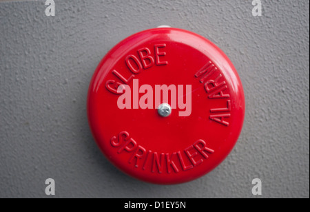 Red fire alarm bell on the wall of a building Stock Photo