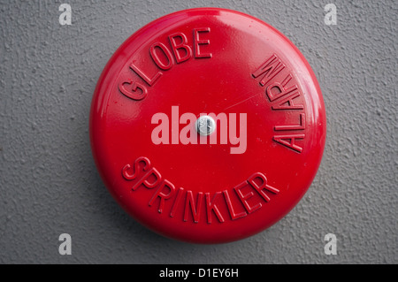 Red fire alarm bell on the wall of a building Stock Photo