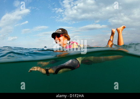 Woman swimming in the Dead Sea, Israel Stock Photo