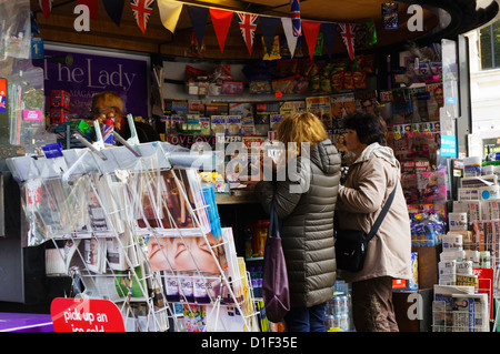 Customers at a newspaper kiosk in Sloane Square, London. Stock Photo