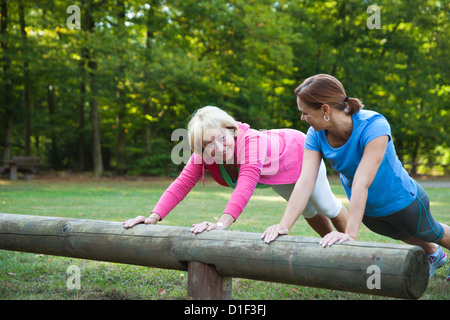Two women doing gymnastics outdoors Stock Photo