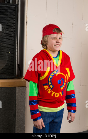 Cheerful boy posing wearing bright red clothes Stock Photo