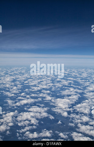white puffy clouds, deep blue sky, seen from and airplane Stock Photo