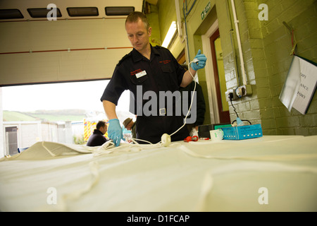 Elderly people bringing their electric blankets to Aberaeron fire station for safety testing organised by AGE Cymru.  Wales UK Stock Photo