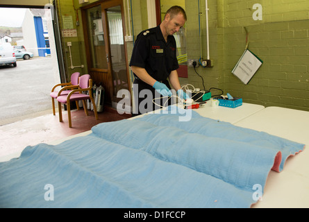 Elderly people bringing their electric blankets to Aberaeron fire station for safety testing organised by AGE Cymru.  Wales UK Stock Photo