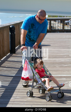 Family on the boardwalk at Johns Pass Village located on the waterfront at Madeira Beach, Florida, USA. Stock Photo