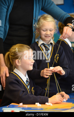 Schoolchildren making spaghetti towers at Our Lady & St. Werburgh's Catholic Primary School in Newcastle-under-Lyme, Staffordshi Stock Photo