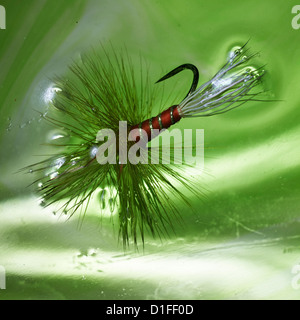 Wulff Red artificial Fishing fly used in angling in extreme close shot in water Stock Photo