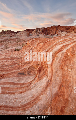 Orange and white sandstone layers with colorful clouds at sunrise, Valley Of Fire State Park, Nevada, United States of America Stock Photo