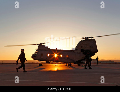 A US Marine Corps pilot prepares to board the last CH-46 Sea Knight helicopter from the Marine Medium Helicopter Squadron 764 as it departs the Edwards Air Force Base flightline for the last time December 19, 2012 in Edwards, CA. The CH-46 will be flown and processed into storage at Davis-Monthan Air Force Base known as the boneyard. Stock Photo