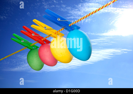 Colorful easter eggs creative concept hanging on a string Stock Photo