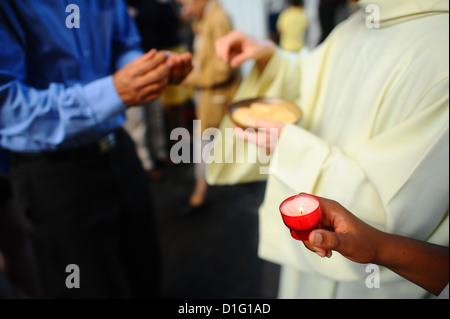 Catholic priest giving Holy Communion, Paris, France, Europe Stock Photo