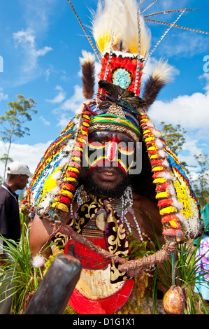 Colourfully dressed and face painted local tribesman celebrating the traditional Sing Sing in the Highlands, Papua New Guinea Stock Photo