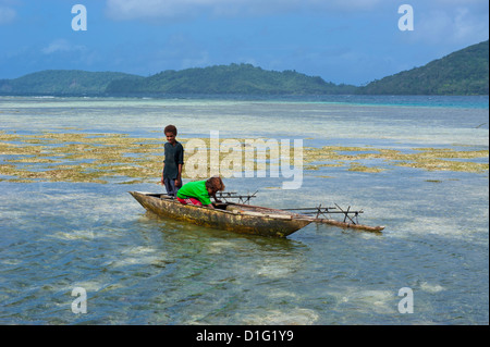 Young boys fishing near Samarai, the old capital, Papua New Guinea, Pacific Stock Photo