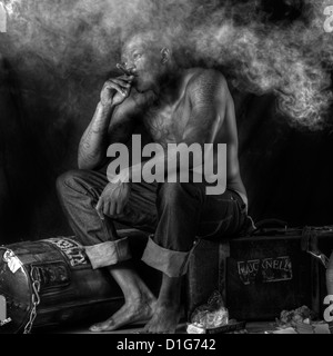 Athelete/boxer taking a rest smoking a cigar Stock Photo