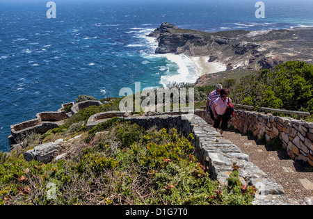 People climbing a s teep path to view the Atlantic Ocean and Diaz beach on a windy day - Cape Point, Stock Photo