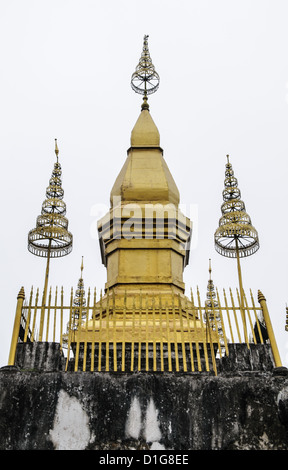 LUANG PRABANG, Laos — That Chomsi, a revered Buddhist stupa, stands prominently on the summit of Mount Phousi, overlooking the historic city of Luang Prabang. Built in 1804, the golden stupa is a significant religious site and offers panoramic views of the city and the Mekong River. That Chomsi is a popular destination for both worshippers and tourists. Stock Photo