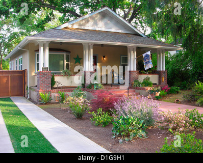 Front exterior yellow bungalow with white verandahs at Chico; California; USA Stock Photo