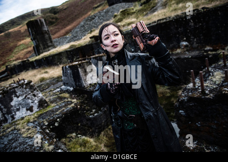 A young woman in 'Post Apocalypse' style cosplay location photo-shoot in Bwlch Glas abandoned lead mine, Mid Wales UK Stock Photo