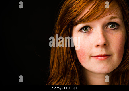 A close up red haired ginger redhead  freckle-faced young adult woman girl female person portrait face Stock Photo