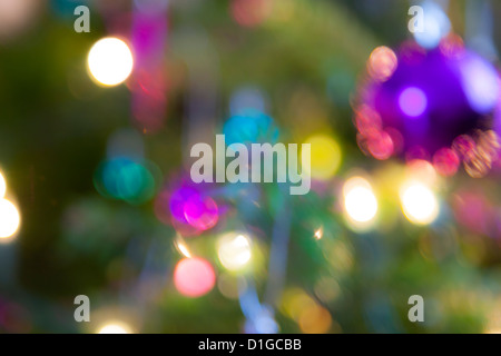 Blurred out of focus Christmas tree lights and baubles, abstract twinkling lights background. Stock Photo
