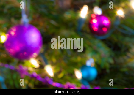 Blurred out of focus Christmas tree lights and baubles, abstract twinkling lights background. Stock Photo