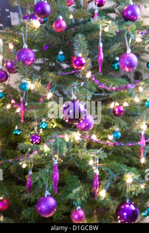 Blurred out of focus Christmas tree lights and baubles, abstract twinkling lights background. Stock Photo