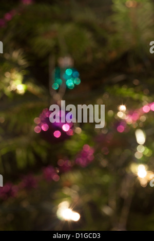 Blurred out of focus Christmas tree lights and baubles, abstract twinkling lights background. Stock Photo