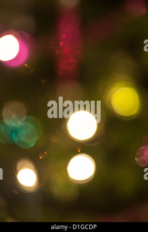 Blurred out of focus Christmas tree lights and baubles, abstract twinkling lights background. Stock Photo