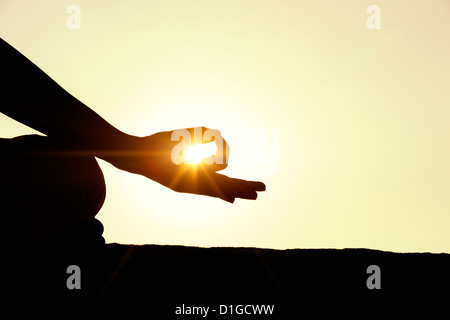 Sunset silhouette of an Indian man meditating. Andhra Pradesh, India Stock Photo