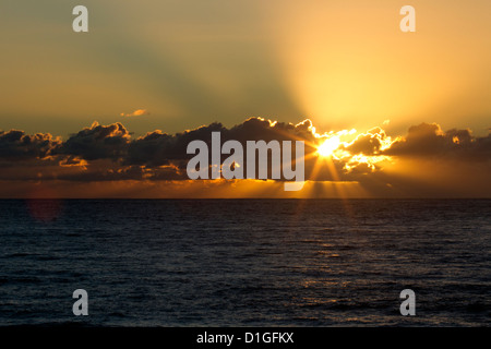 Sun rays from behind low clouds Stock Photo