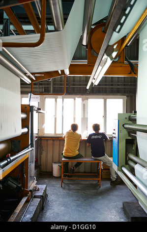 Two workers having a lunch break while staring out the window Stock Photo