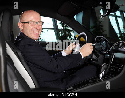 The head of sales and market of sports car manufacturer Porsche AG, Bernhard Maier, poses with a Porsche Cayman at the Porsche Museum in Stuttgart, Germany, 18 December 2012. Photo: Bernd Weissbrod Stock Photo