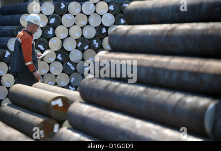 (dpa FILE) - An archive picture, dated 22 March 2012, shows a steelworker walking past blank steel rods at the plug rolling mill of 'Vallurec & Mannesmann' in Duesseldorf, Germany. Steel makers in Germany may staret the year 2013 with a glimmer of hope, despite the fact that a general recovery for the steel industries may not be very likely. Over capacity in Europe is the cause for ongoing debates. Photo: Federico Gambarini Stock Photo