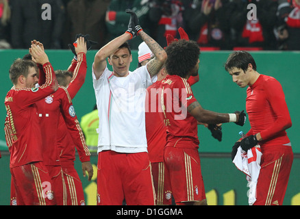 Munich's Philipp Lahm (L-R), Anatoliy Tymoshchuk, Dante and Javier Martinez celebrate their 2-0 victory after the round of the last 16 DFB Cup match between FC Augsbirg and Bayern Munich at SGL Arena in Augsburg, Germany, 18 December 2012. Photo: Karl-Josef Hildenbrand Stock Photo
