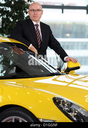 The head of sales and market of sports car manufacturer Porsche AG, Bernhard Maier, poses with a Porsche Cayman at the Porsche Museum in Stuttgart, Germany, 18 December 2012. Photo: Bernd Weissbrod Stock Photo