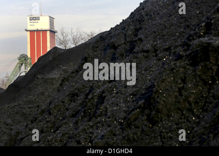 Mined coal is piled up in front of the winding towers at the West mine in Kamp-Lintfort, Germany, 20 December 2012. The mine is shut down at the end of the year. Photo: ROLAND WEIHRAUCH Stock Photo