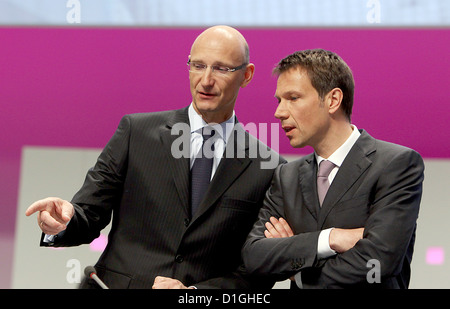 Deutsche Telekom CEO Rene Obermann (R) and CFO Timotheus Hoettges (L) talks ahead of the German telecommunication giant's general meeting in Cologne, Germany, 03 May 2010. Photo: OLIVER BERG Stock Photo