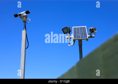 solar powered CCTV camera on pole; against a clear blue cloudless sky Stock Photo